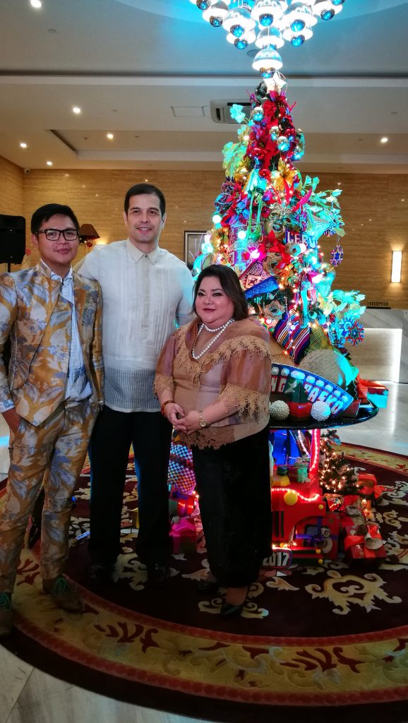 Designer Michael Francis Mayores, PBA legend Alvin Patrimonio and Director of Sales & Marketing, Ms. Christine Ann Ibarreta photo-op at the Golden Phoenix Hotel Manila's "POP Pinoy" Christmas Tree.
